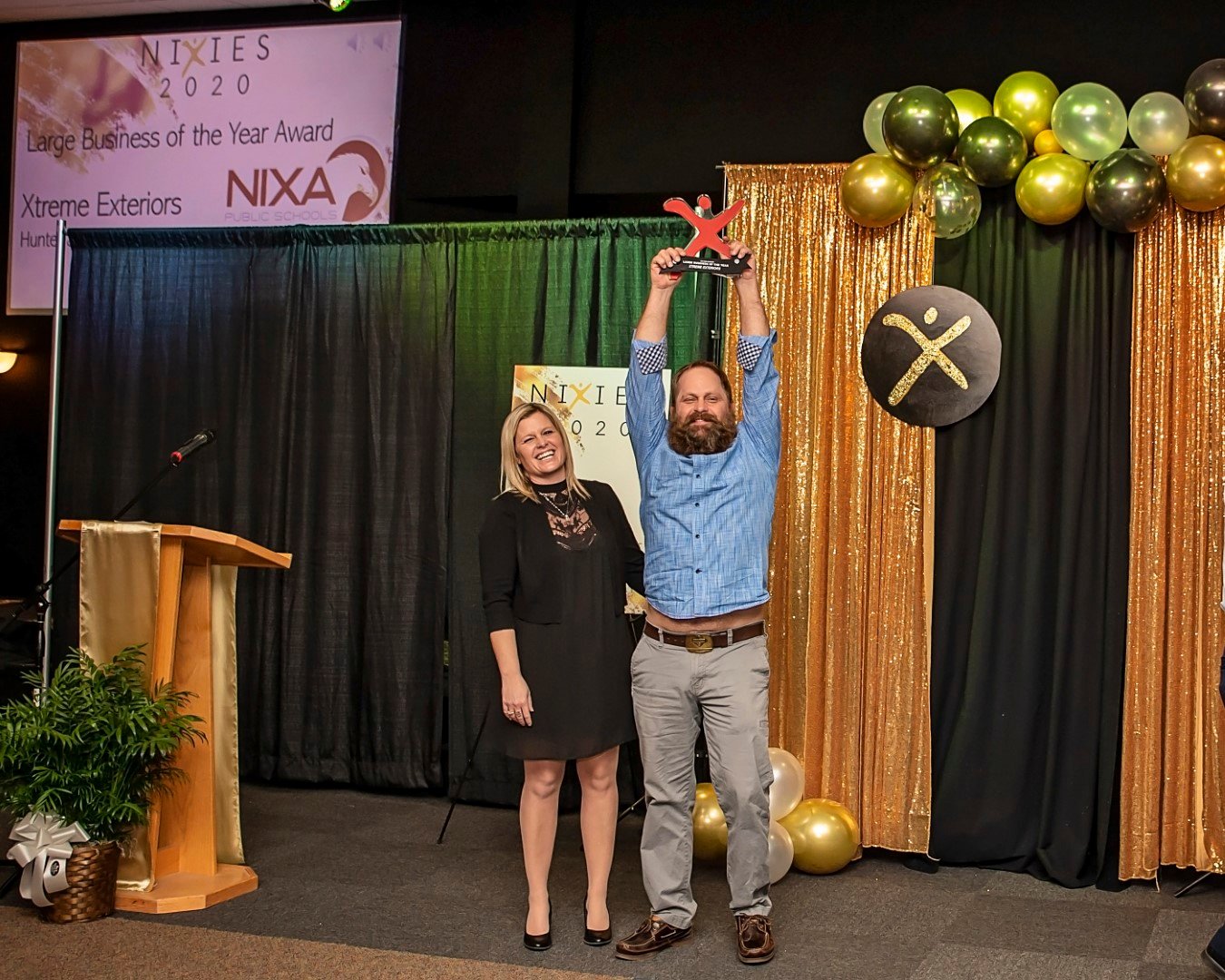 Summer and Hunter Lampe of Xtreme Exteriors celebrate their win last month for the chamber's Large Business of the Year.